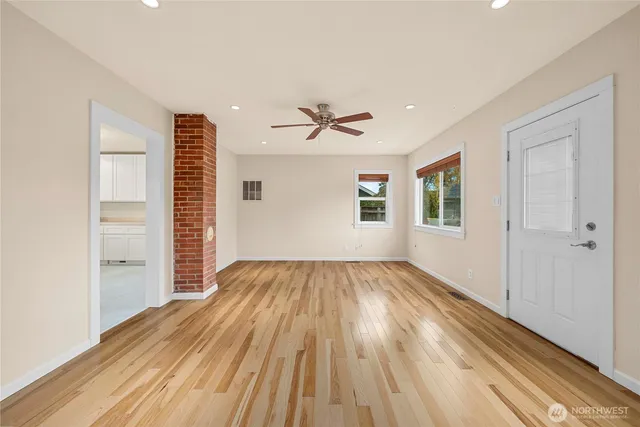 wooden floor in an empty room with a window