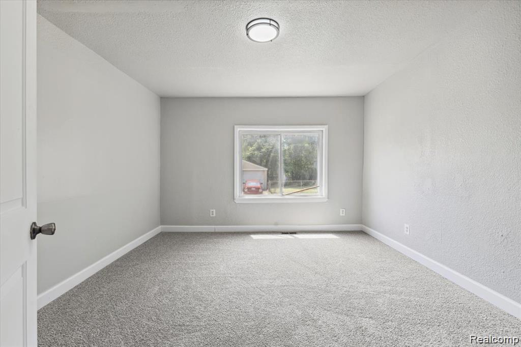 3140 Moore Street Inkster, MI 48141 - Photo 14 of 18 Neutral-toned room featuring a single window, overhead flush-mount lighting, and light grey carpeting