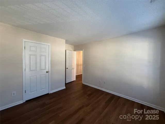a view of an empty room and wooden floor
