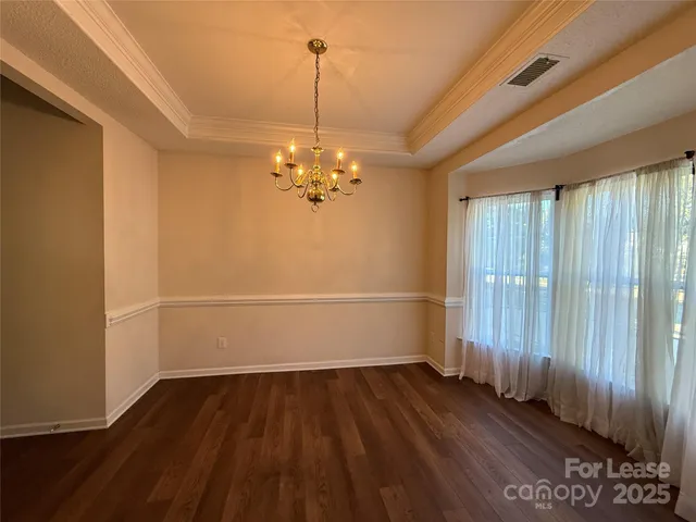 a view of a room with wooden floor fan and window