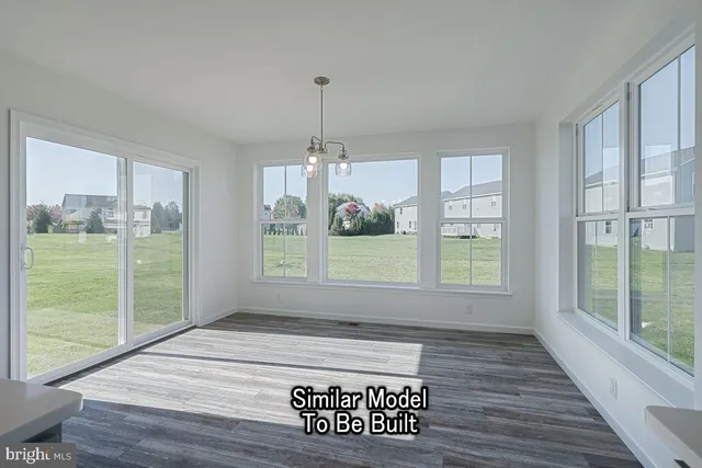 a view of an empty room with glass door and balcony