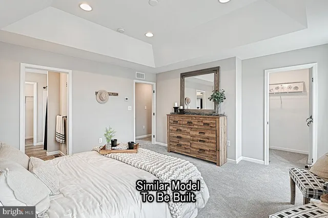 a bedroom with a bed and a dresser