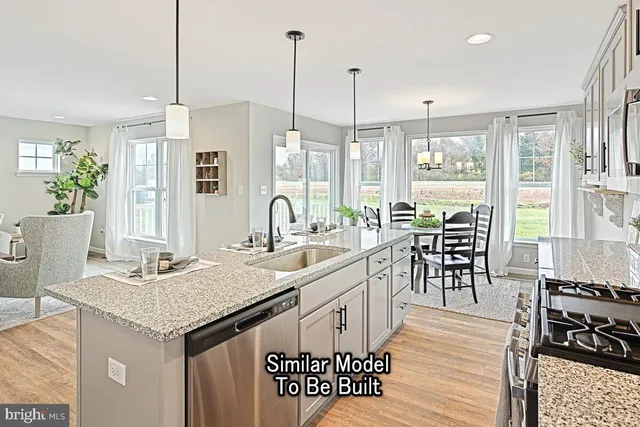 a kitchen with sink stove and dining table