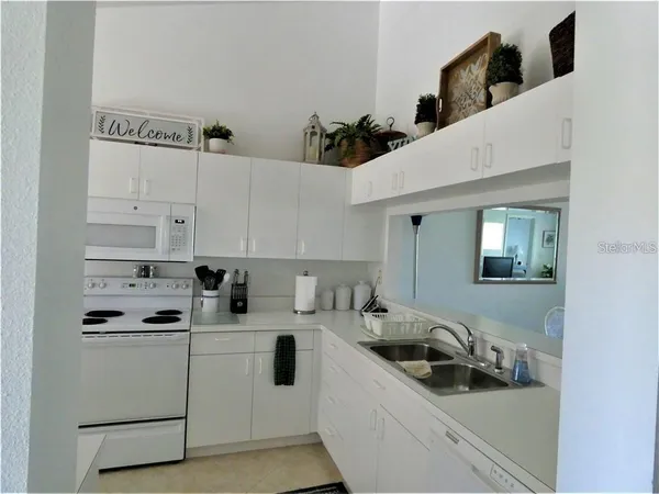a kitchen with stainless steel appliances a sink a stove and a refrigerator