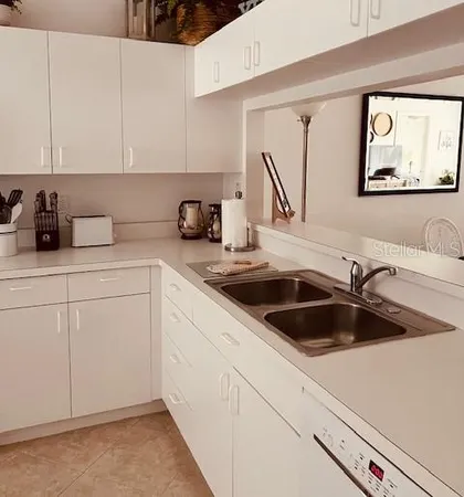 a kitchen with sink cabinets and window