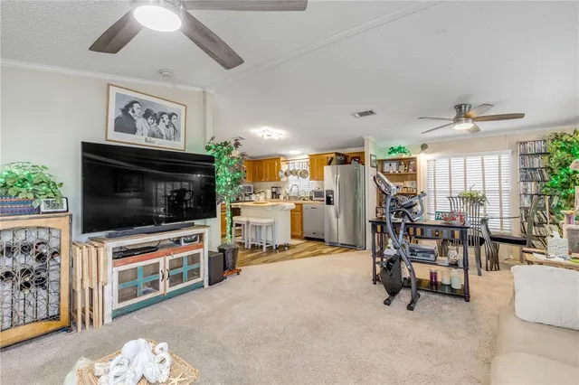 a view of a livingroom with furniture and floor to ceiling window