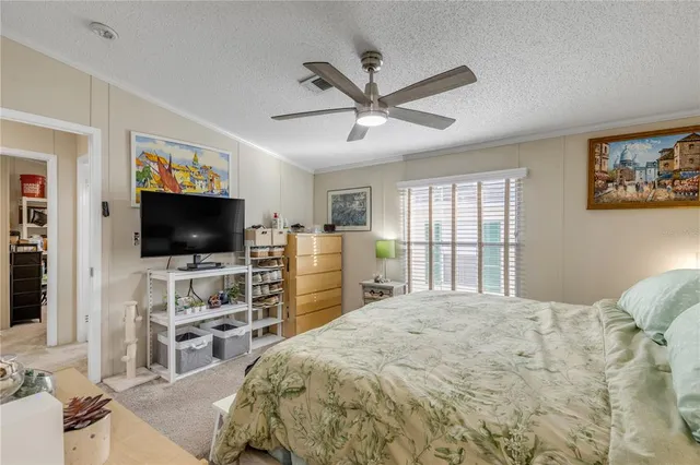 a view of a workspace with furniture and a flat screen tv