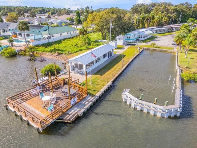 a view of swimming pool with outdoor seating and yard in the back