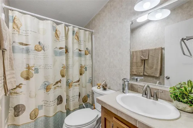 a front view of a house with a yard and mountain view