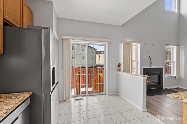 a view of kitchen with furniture and refrigerator