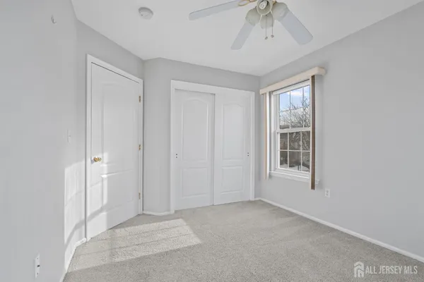 an empty room with windows and closet