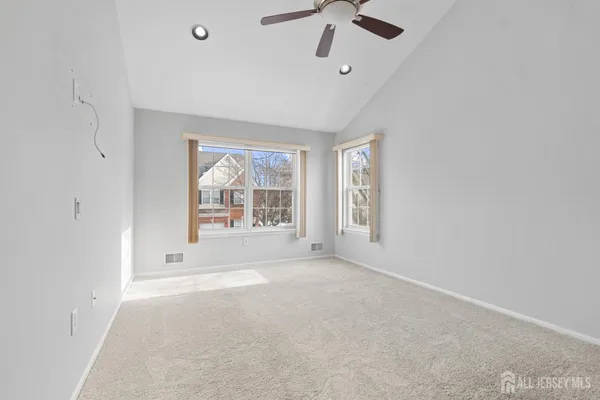 an empty room with a empty space and windows