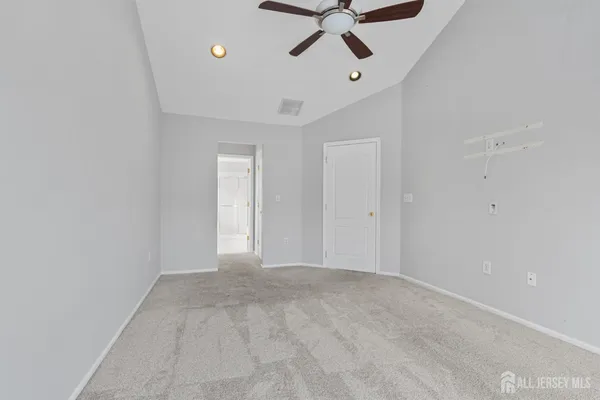 a view of a room with a ceiling fan