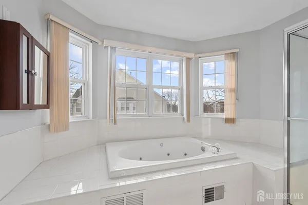a white bath tub sitting next to a window