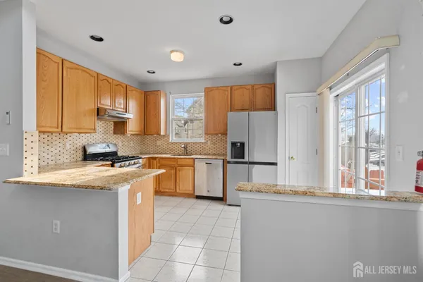 a kitchen with a sink appliances cabinets and a counter top space