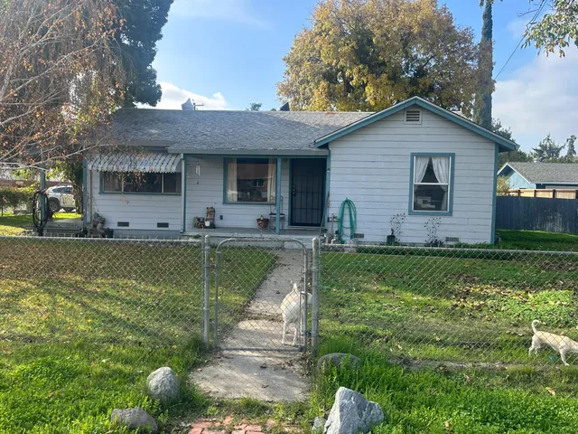 a view of a house with a yard patio and sitting area