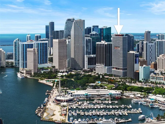 an aerial view of residential houses with outdoor space and ocean view