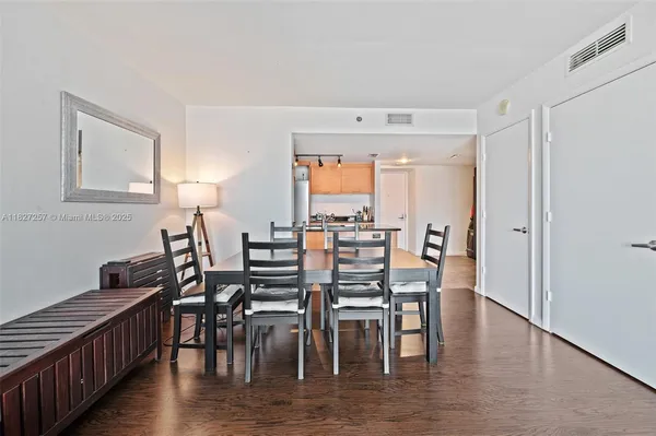a view of a a dining room with furniture window and wooden floor