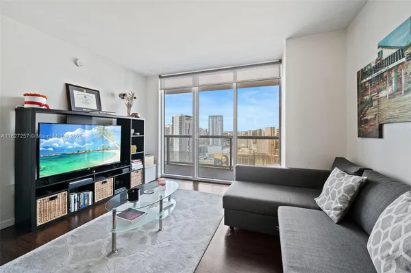a living room with furniture and a flat screen tv