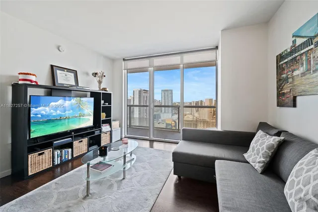 a living room with furniture and a flat screen tv