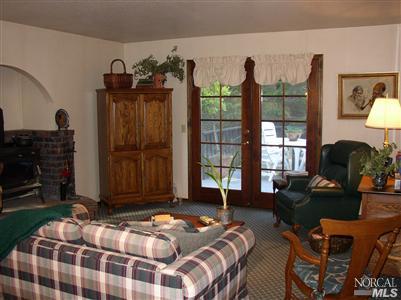 2172 Green Hill Road Sebastopol, CA 95472 - Photo 8 of 12 a bedroom with a bed a dresser and mirror
