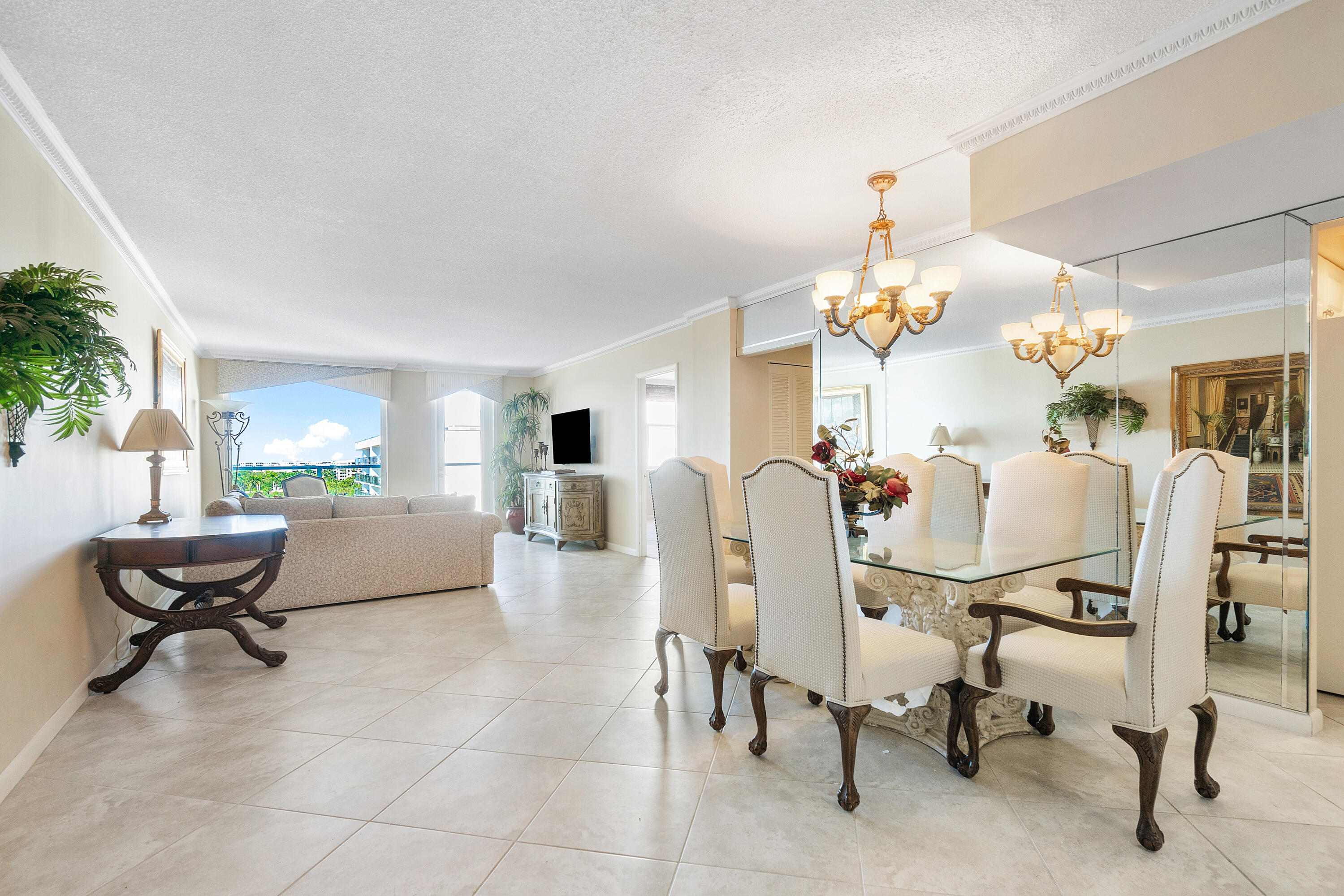 3450 South Ocean Boulevard, Unit 625 Palm Beach, FL 33480 - Photo 12 of 43 a living room with furniture a dining table and a chandelier