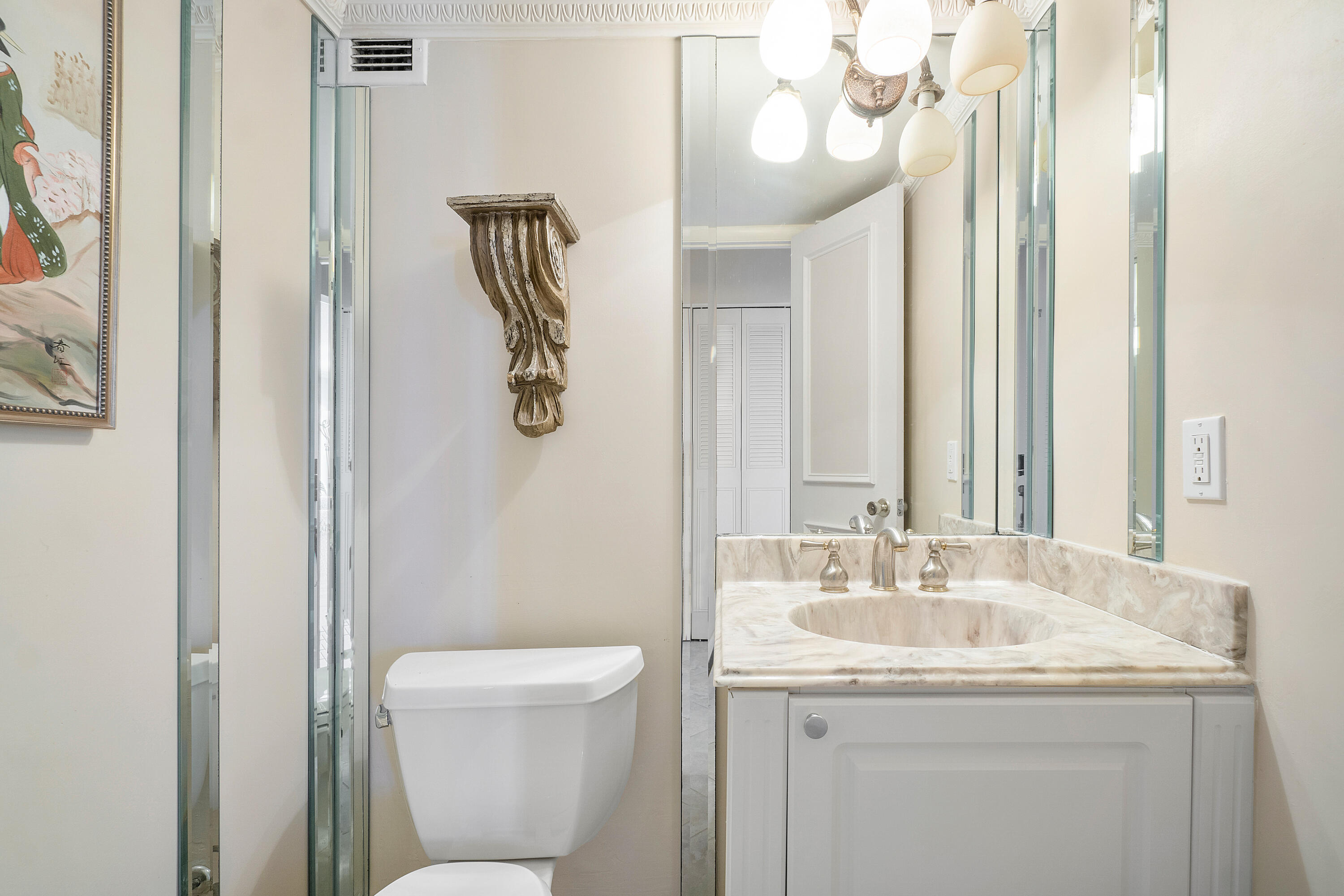 3450 South Ocean Boulevard, Unit 625 Palm Beach, FL 33480 - Photo 10 of 43 a bathroom with a granite countertop sink a toilet and a mirror