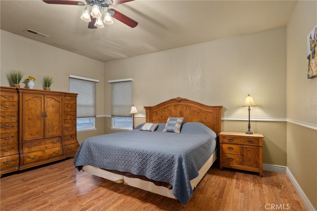 3385 Keefer Road Chico, CA 95973 - Photo 17 of 40 a bedroom with a bed and wooden floor