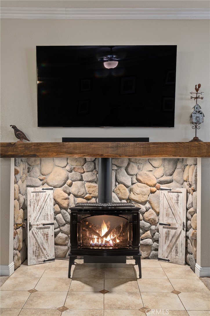 3385 Keefer Road Chico, CA 95973 - Photo 8 of 40 a living room with a fireplace and a flat screen tv