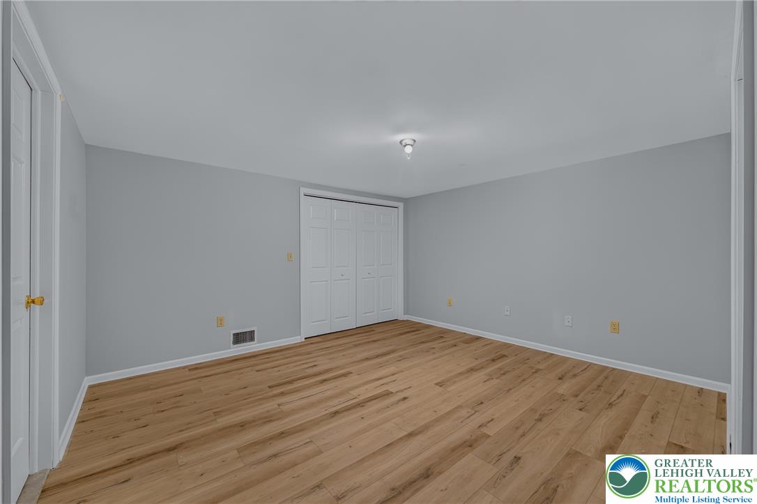 630 Clearfield Road Nazareth, PA 18064 - Photo 77 of 100 Gleaming wood-look floors pair beautifully with crisp, neutral walls in this versatile bedroom.