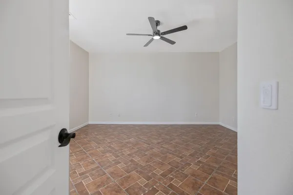 a view of a livingroom with a ceiling fan and window