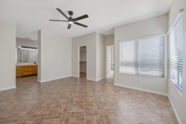 a view of a livingroom with a ceiling fan and window