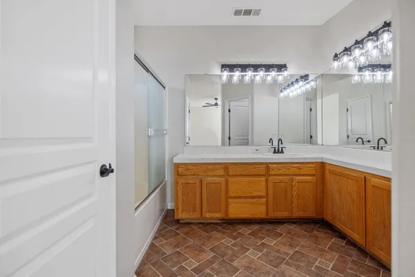 a spacious bathroom with a mirror a sink and a bathtub