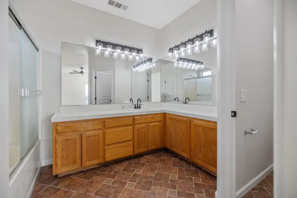 a spacious bathroom with a double vanity sink mirror and