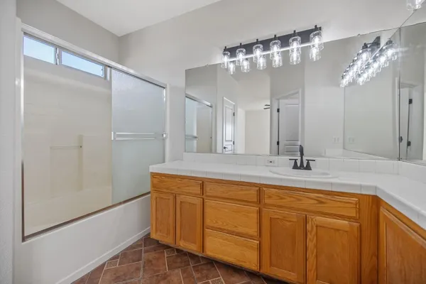 a bathroom with a double vanity sink and mirror