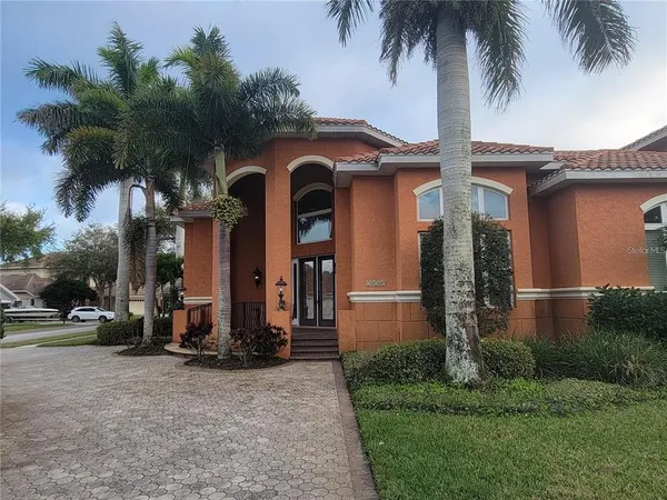 front view of house with a yard and potted plants