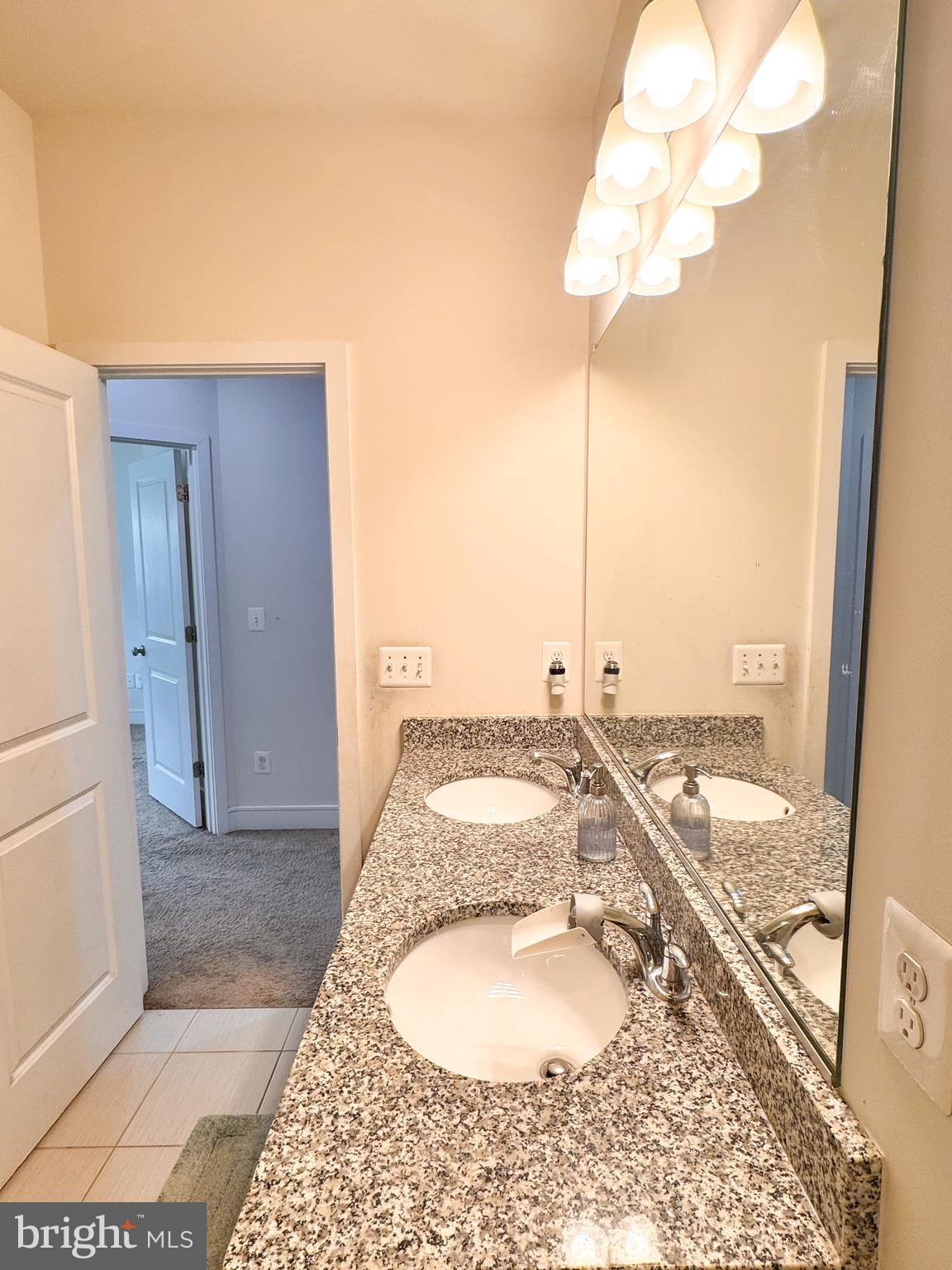 25419 Reed Orchard Terrace Chantilly, VA 20152 - Photo 45 of 47 a bathroom with a granite countertop sink and a mirror