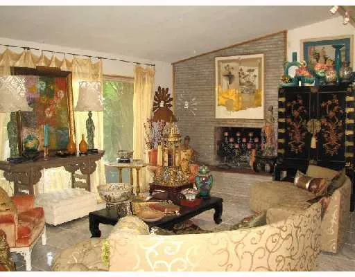 a living room with fireplace furniture and a window