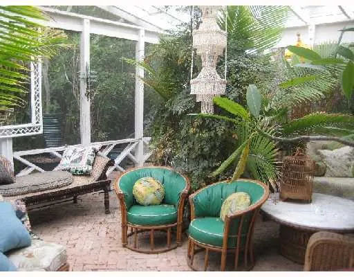 a outdoor living room with furniture and a potted plant