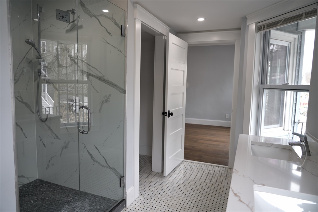 75 Tower Street, Unit 2 Boston, MA 02130 - Photo 7 of 15 a bathroom with a glass shower door
