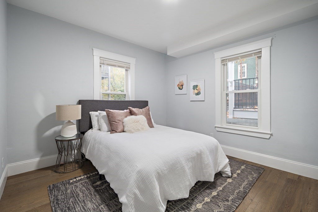 75 Tower Street, Unit 2 Boston, MA 02130 - Photo 8 of 15 a bedroom with a bed lamp and a window