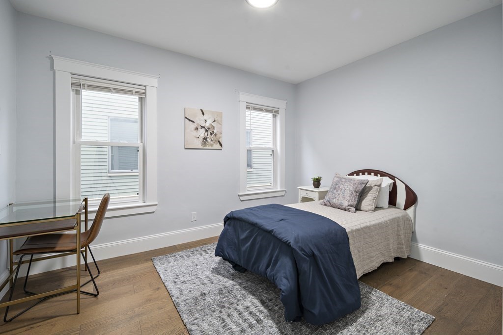 75 Tower Street, Unit 2 Boston, MA 02130 - Photo 9 of 15 a bed room with a bed and a chair