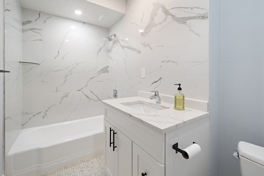 75 Tower Street, Unit 2 Boston, MA 02130 - Photo 10 of 15 a bathroom with a sink vanity and a bathtub