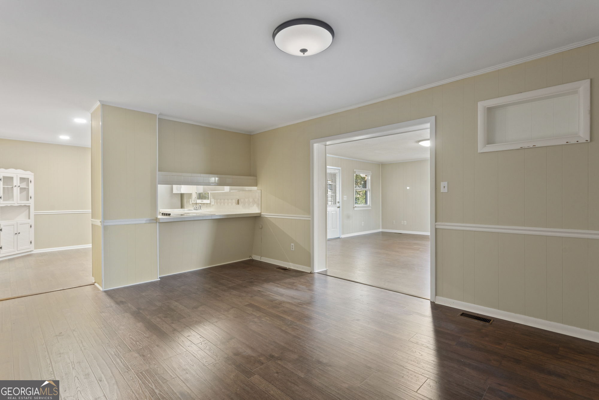 1423 Tucker Road Perry, GA 31069 - Photo 11 of 37 an empty room with wooden floor and windows