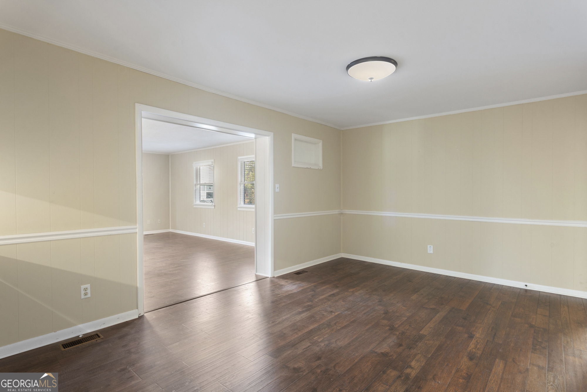 1423 Tucker Road Perry, GA 31069 - Photo 12 of 37 an empty room with wooden floor and windows