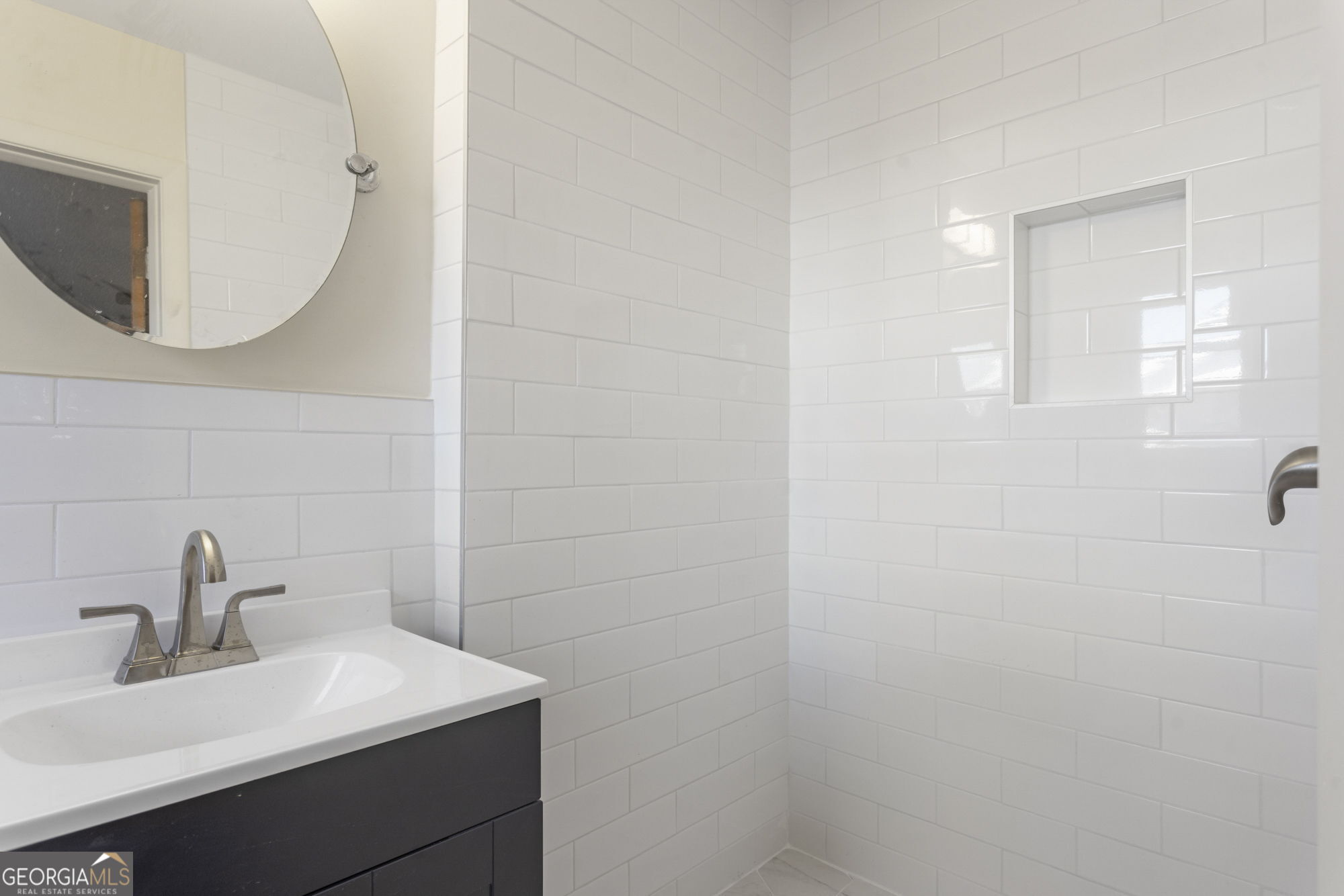 1423 Tucker Road Perry, GA 31069 - Photo 17 of 37 a bathroom with a sink a mirror and vanity