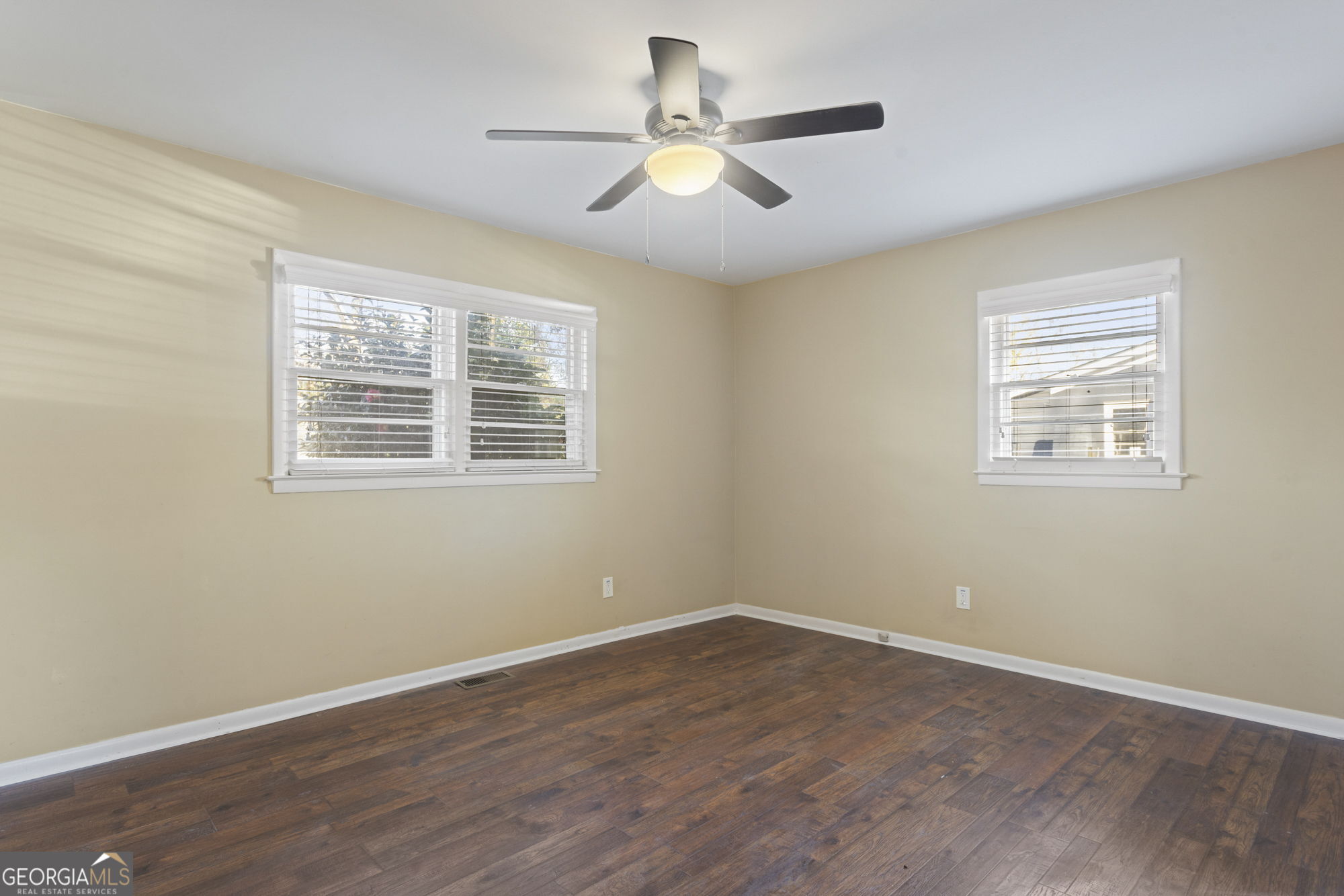 1423 Tucker Road Perry, GA 31069 - Photo 19 of 37 a view of an empty room with wooden floor and a window