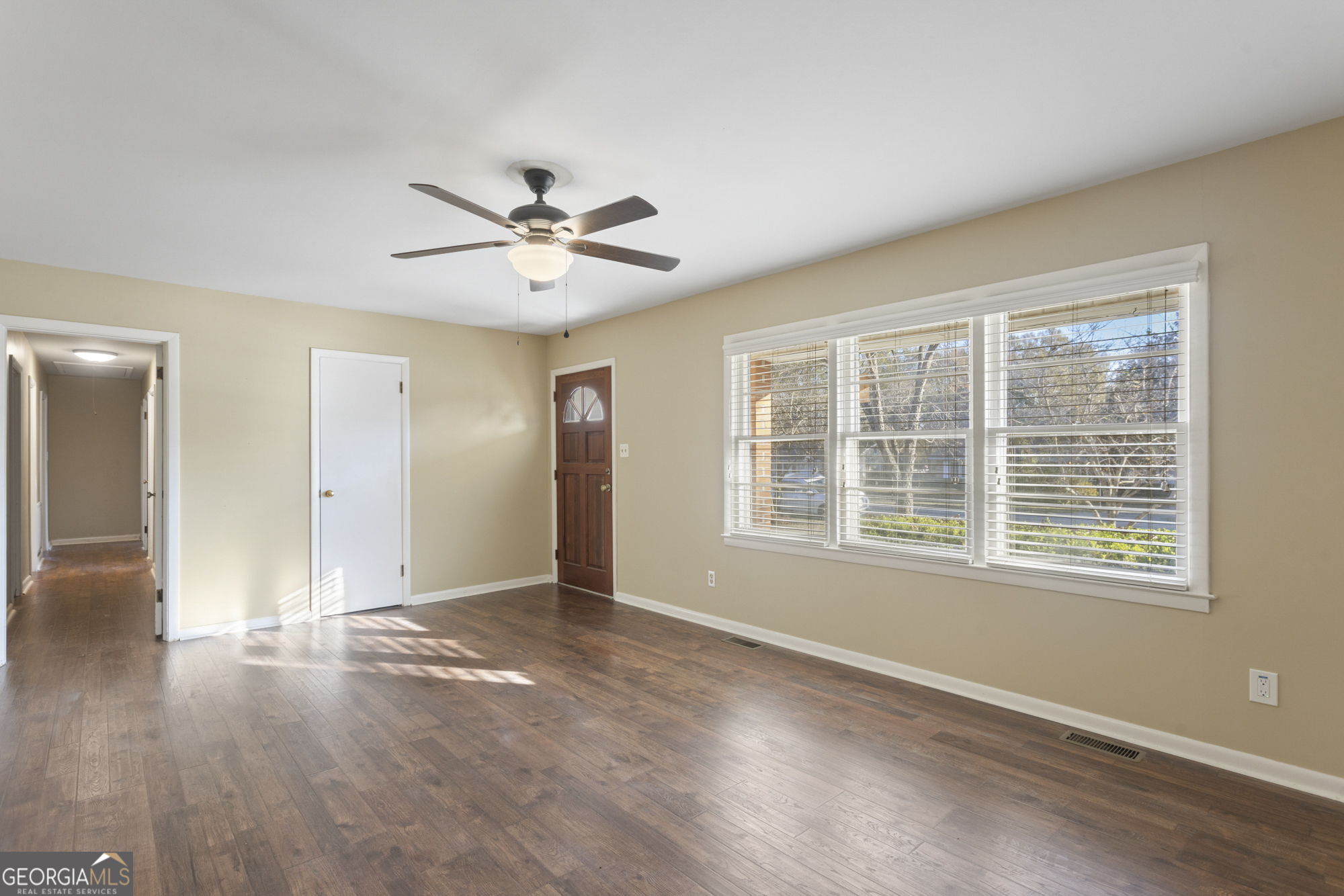 1423 Tucker Road Perry, GA 31069 - Photo 2 of 37 a view of an empty room with a window and wooden floor