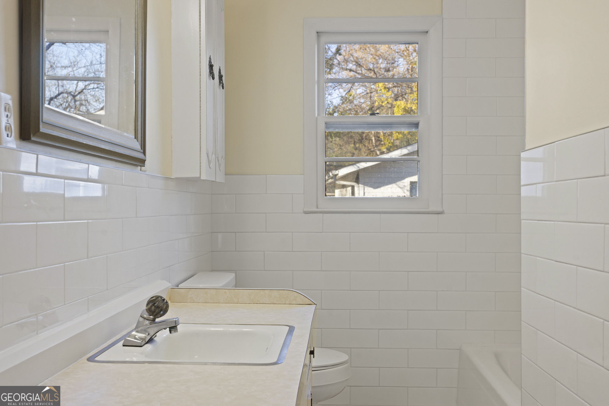 1423 Tucker Road Perry, GA 31069 - Photo 21 of 37 a bathroom with a window and a shower