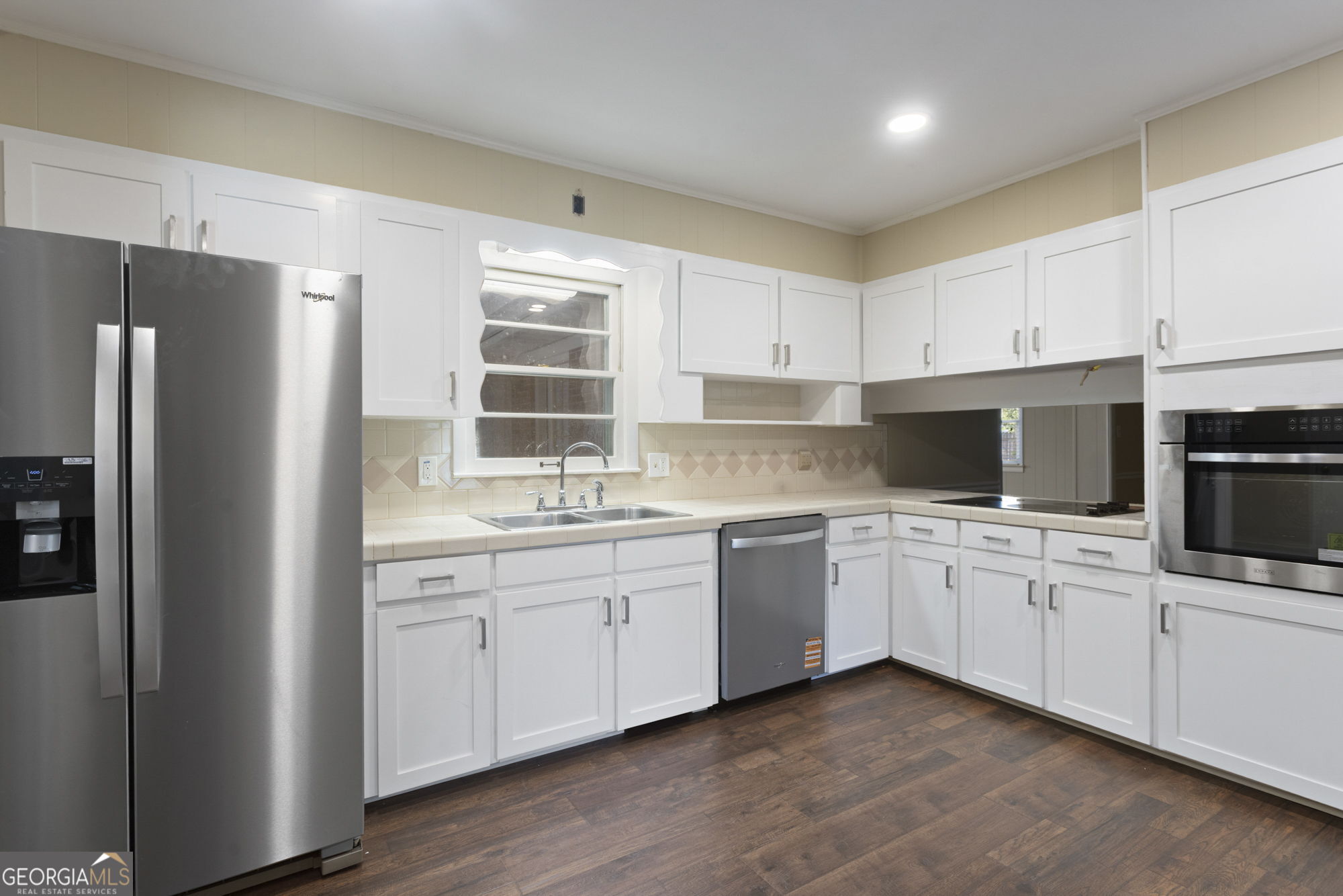 1423 Tucker Road Perry, GA 31069 - Photo 5 of 37 a kitchen with appliances a sink and cabinets